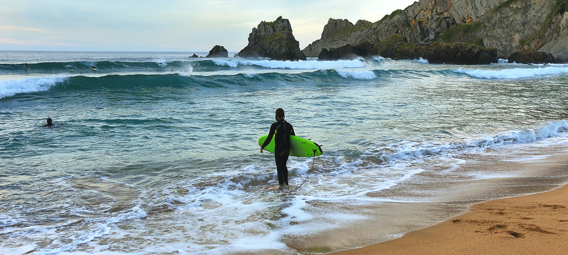 Surfer at Laga beach in Vizcaya, the Basque Country