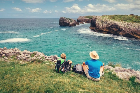  Pilgrims resting with a view of the coast on the Northern Way of Saint James