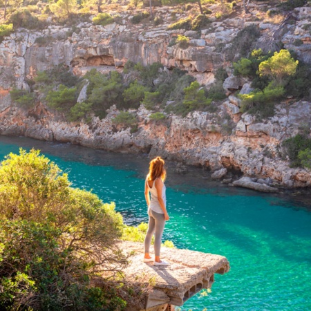 Tourist looking out over Cala del Pi in Mallorca, Balearic Islands