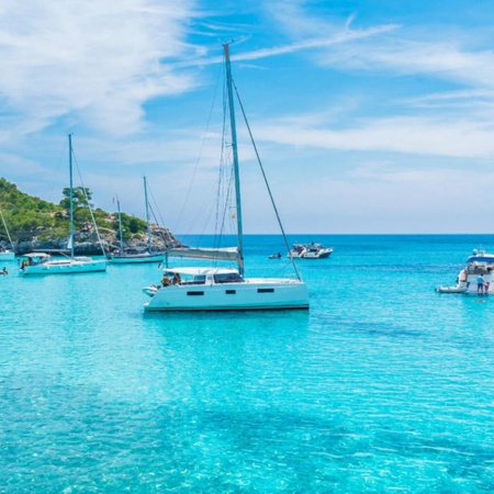 Boats in the turquoise waters of Mondragó Cove. Majorca