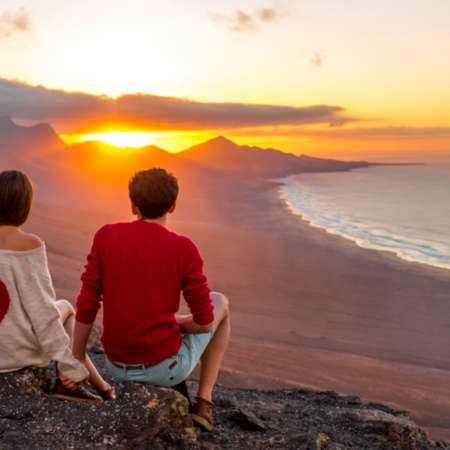 Couple in love looking at the landscape in Fuerteventura (Canary Islands).