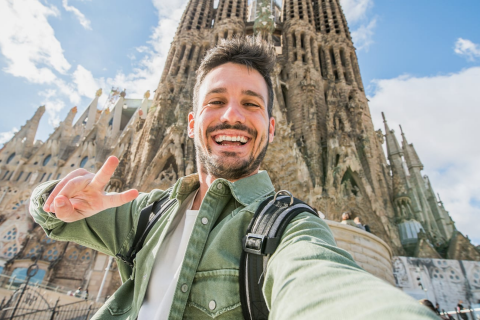 Ein Tourist macht ein Selfie an der Sagrada Familia in Barcelona, Katalonien