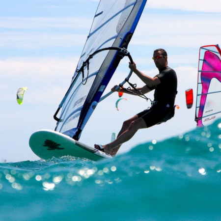 A windsurfer riding a wave.