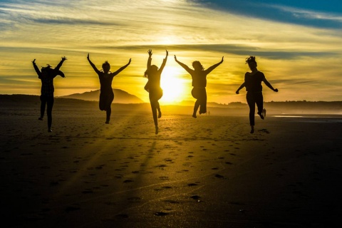 Friends on a beach in Galicia at sunset