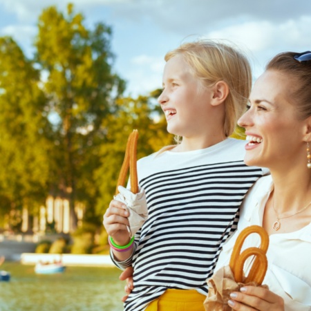 Mother and daughter eating some churros in the Retiro Park in Madrid, Region of Madrid