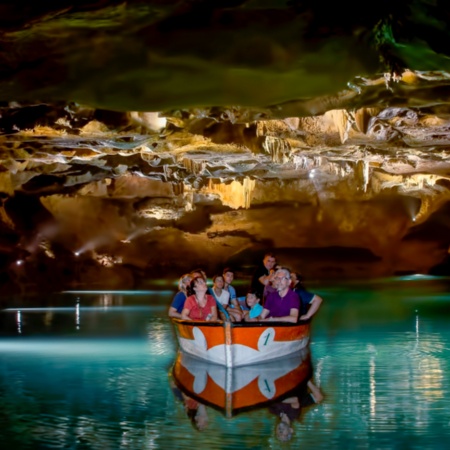 Tourists looking at the Caves of San José de La Vall D