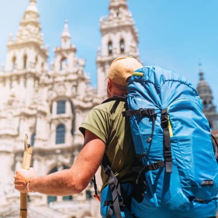 A pilgrim in front of Santiago de Compostela Cathedral