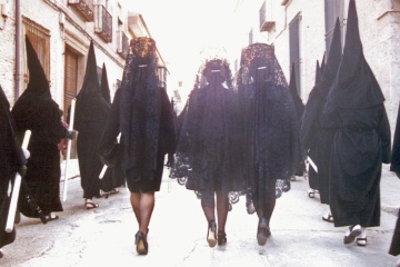 Woman wearing traditional lace mantillas during an Easter Week procession in Ocaña