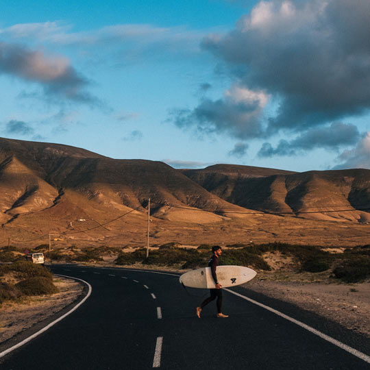 Surfista em uma estrada de Lanzarote (Ilhas Canárias)