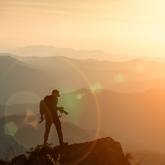 Fotograf auf einem Berggipfel