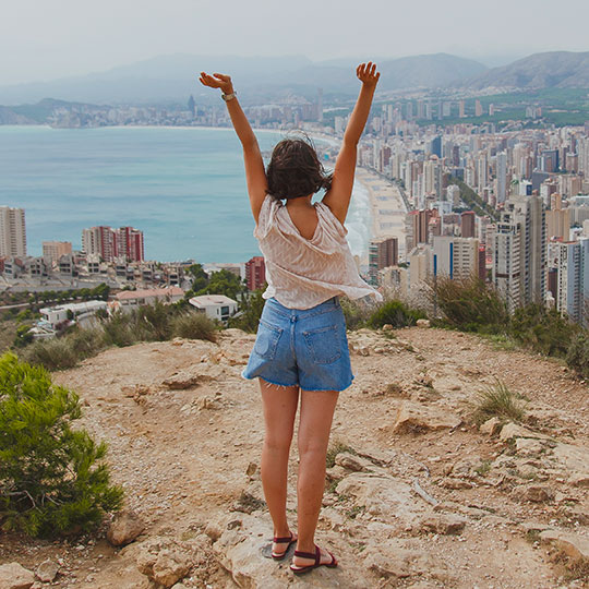 Turista che ammira le vedute della città di Benidorm, Alicante