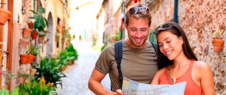 Couple strolling through the streets of Valldemossa in Mallorca, Balearic Islands