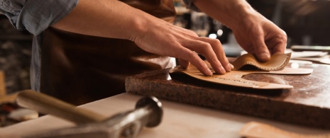 Craftsman making leather products