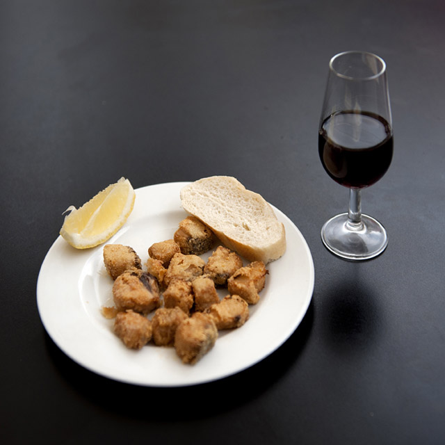 Tapa of adobo and glass of wine