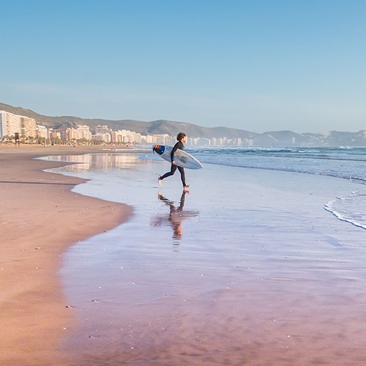 Surfer on Cullera beach in Valencia