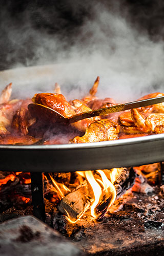 Cooking a paella over a fire