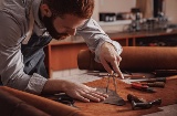Craftsman working with leather