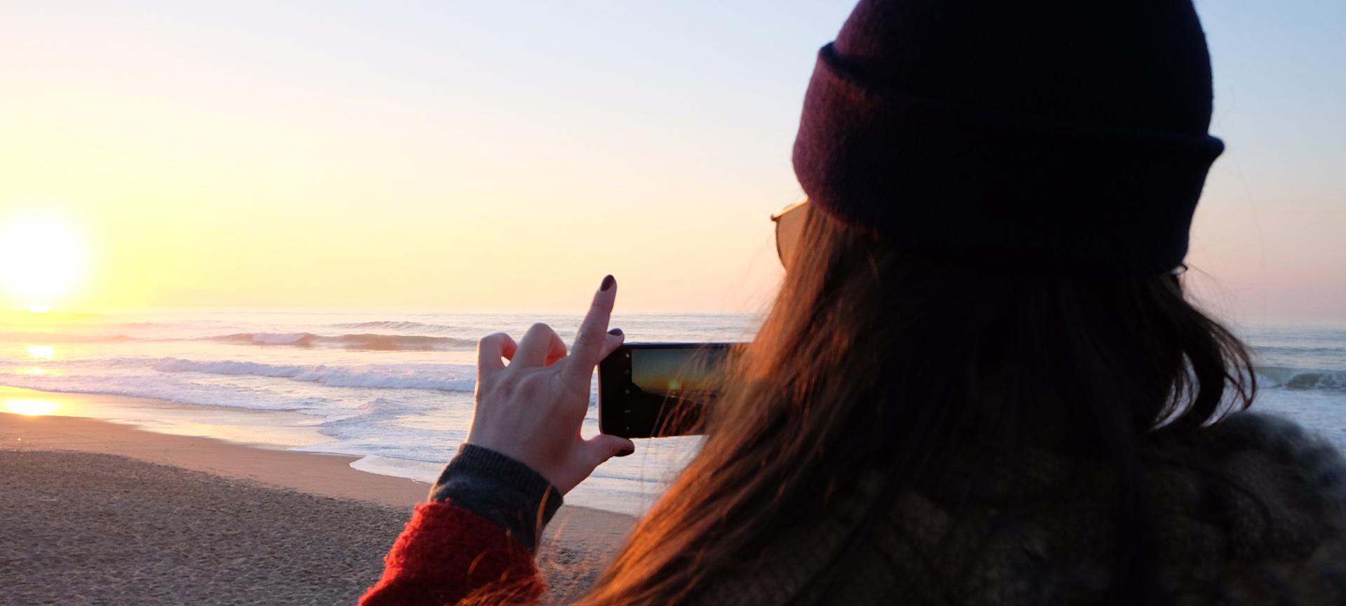 Girl taking a photograph at sunset Girl taking a photograph at sunset