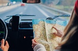 Girl looking at a map in a car in Spain