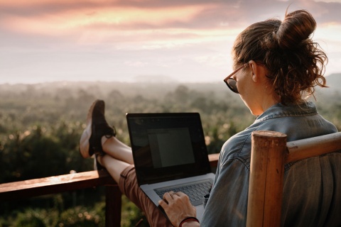 Girl working with countryside views