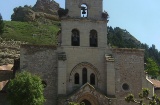 Exterior of the Church of Santa María with the castle in the background, in Belorado