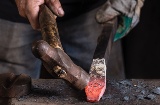 Craftsman working on a sword in a workshop in Toledo.