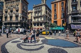 People passing by the Miró mosaic on Las Ramblas. Barcelona
