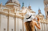 Tourist taking a photograph of the Basílica del Pilar in Zaragoza, Aragón