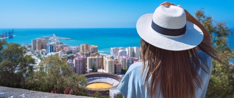 Girl looking at the view from the Gibralfaro viewpoint in Malaga, Andalusia