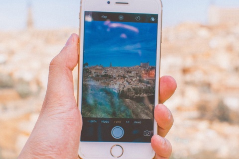 Person taking a photo of Toledo on their phone