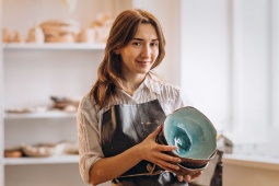 Craftswoman in pottery shop